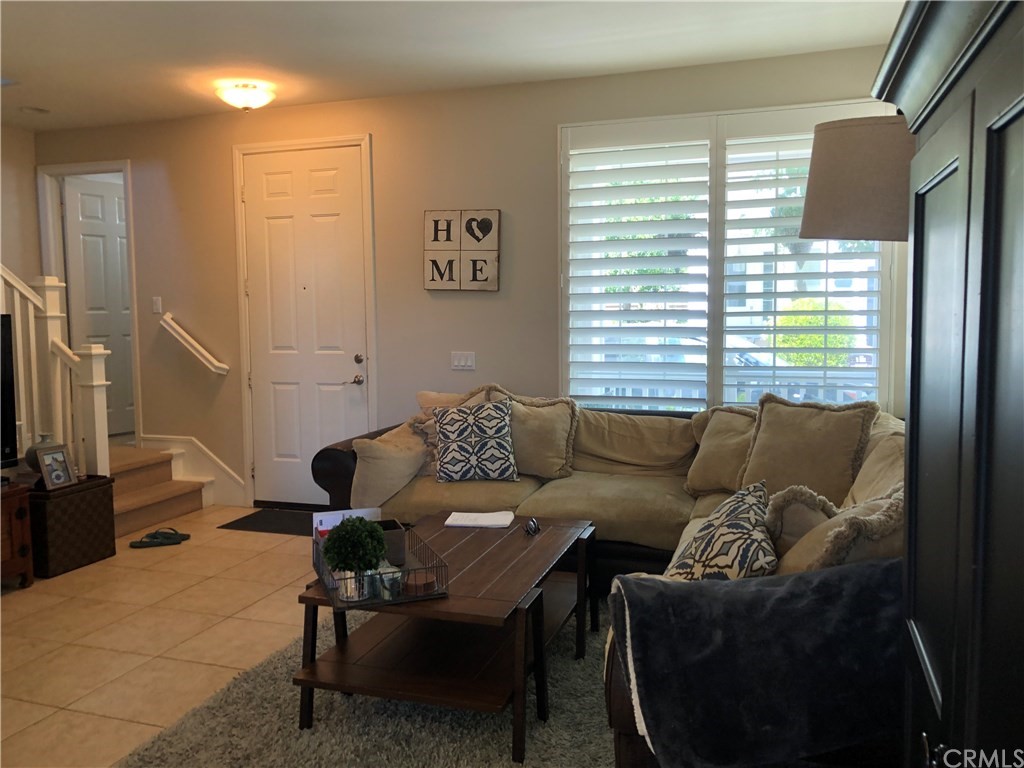 303 Canoe Pond Costa Mesa, CA 92627 - Photo 16 of 49 a living room with furniture and a window