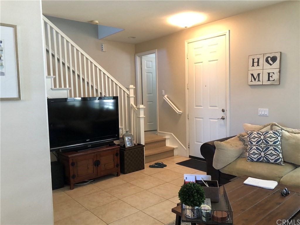 303 Canoe Pond Costa Mesa, CA 92627 - Photo 17 of 49 a living room with furniture and a flat screen tv