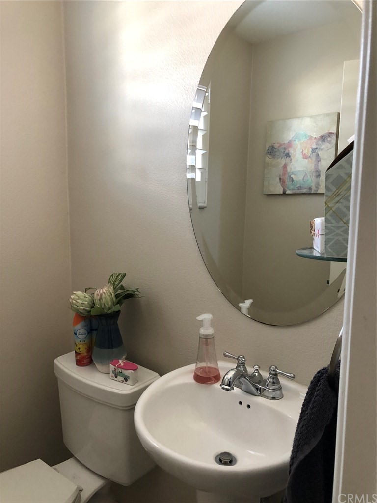 303 Canoe Pond Costa Mesa, CA 92627 - Photo 18 of 49 a bathroom with a toilet sink and mirror
