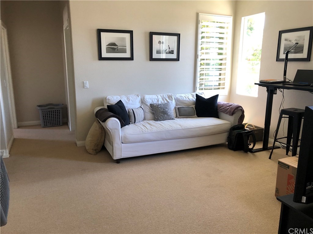 303 Canoe Pond Costa Mesa, CA 92627 - Photo 21 of 49 a living room with furniture a flat screen tv and a window
