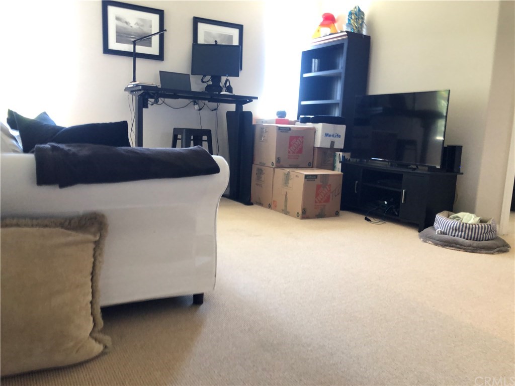 303 Canoe Pond Costa Mesa, CA 92627 - Photo 22 of 49 a living room with furniture a flat screen tv and dresser