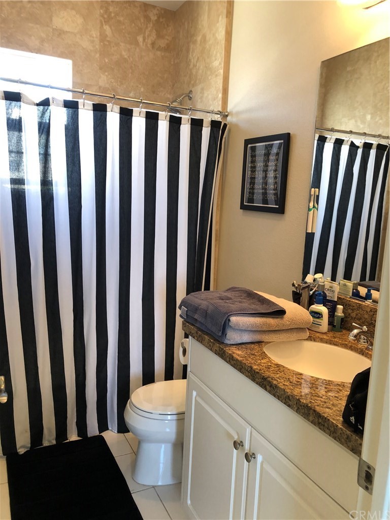 303 Canoe Pond Costa Mesa, CA 92627 - Photo 24 of 49 a bathroom with a granite countertop sink and a mirror