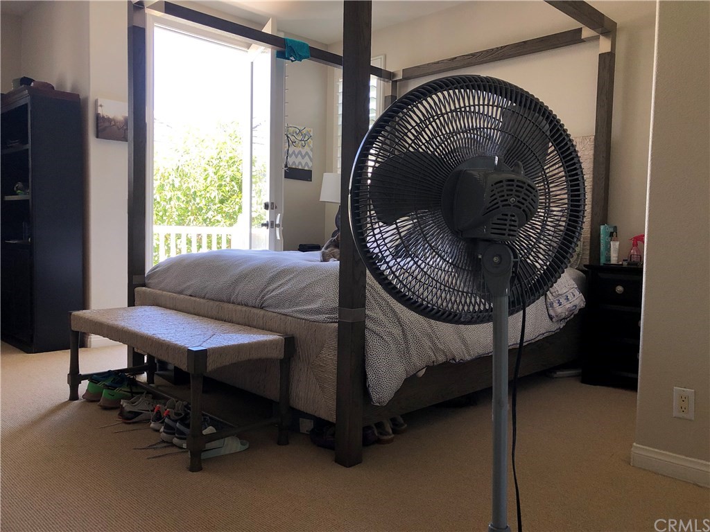 303 Canoe Pond Costa Mesa, CA 92627 - Photo 26 of 49 a bedroom with a bed chair and a window