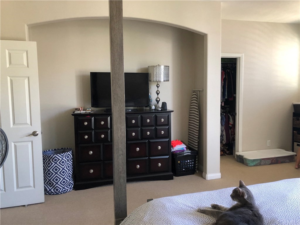 303 Canoe Pond Costa Mesa, CA 92627 - Photo 28 of 49 a bedroom with a bed and a television