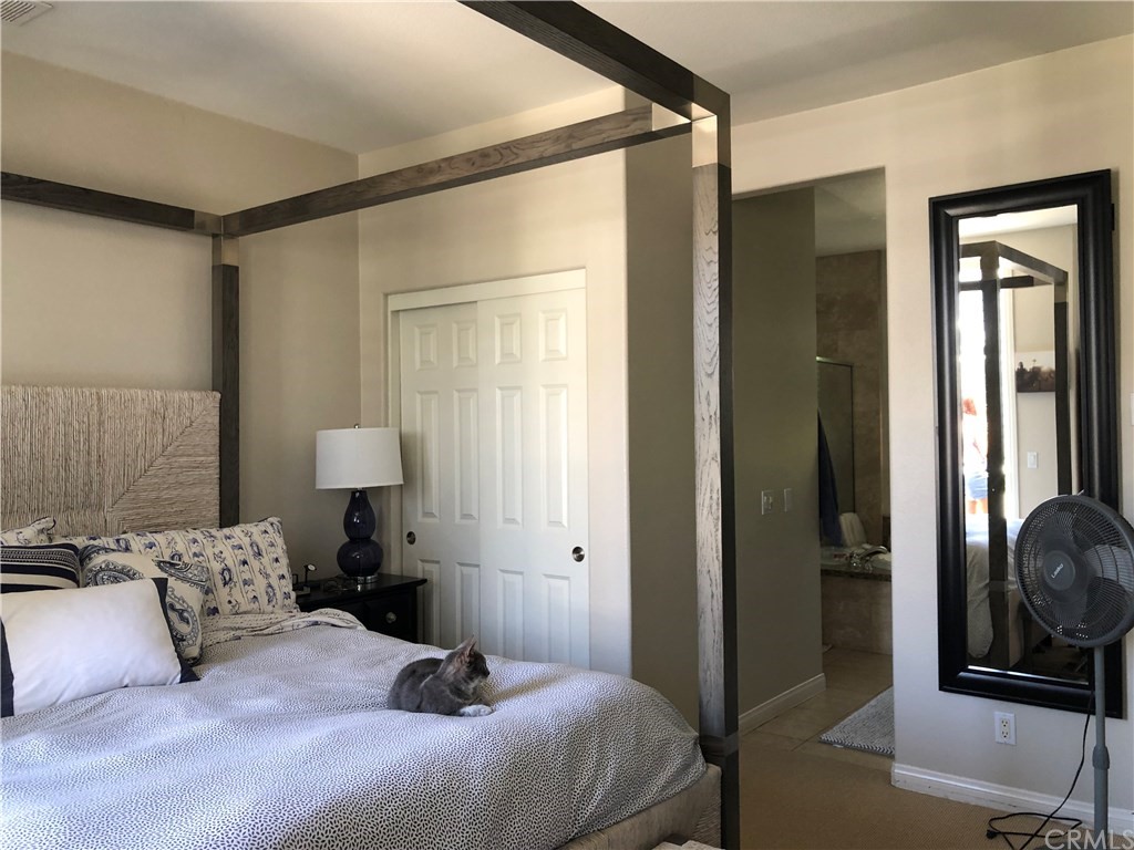 303 Canoe Pond Costa Mesa, CA 92627 - Photo 34 of 49 a bedroom with a bed and a mirror