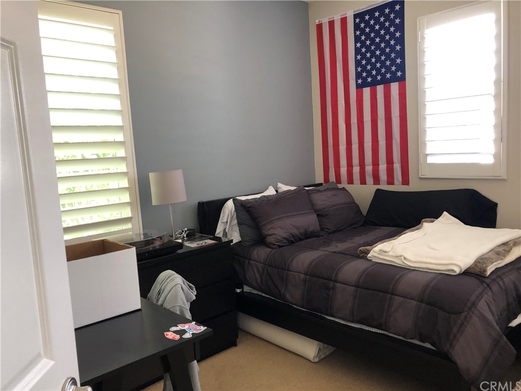 303 Canoe Pond Costa Mesa, CA 92627 - Photo 38 of 49 a blue bed sitting in a bedroom next to a window