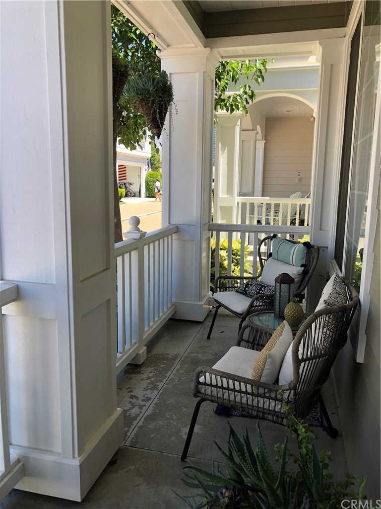 303 Canoe Pond Costa Mesa, CA 92627 - Photo 4 of 49 a balcony with chairs and a potted plant