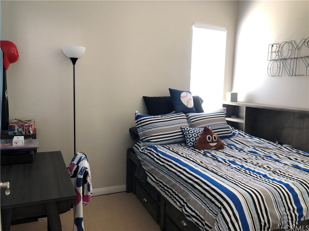 303 Canoe Pond Costa Mesa, CA 92627 - Photo 41 of 49 a bedroom with a bed and a window