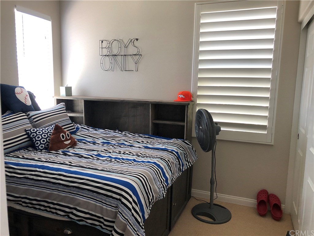 303 Canoe Pond Costa Mesa, CA 92627 - Photo 42 of 49 a bedroom with a bed and a window