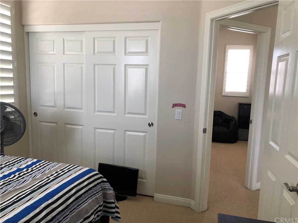 303 Canoe Pond Costa Mesa, CA 92627 - Photo 43 of 49 a bedroom with a bed and a closet