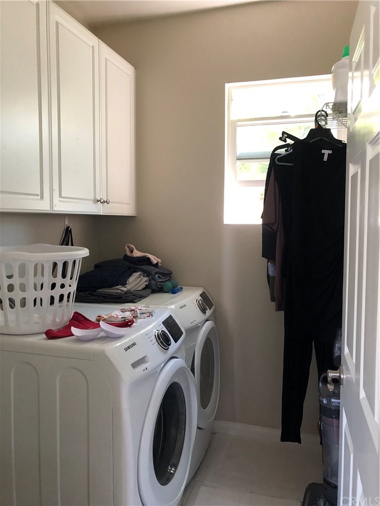 303 Canoe Pond Costa Mesa, CA 92627 - Photo 44 of 49 a view of walk in closet with clothes and shoes