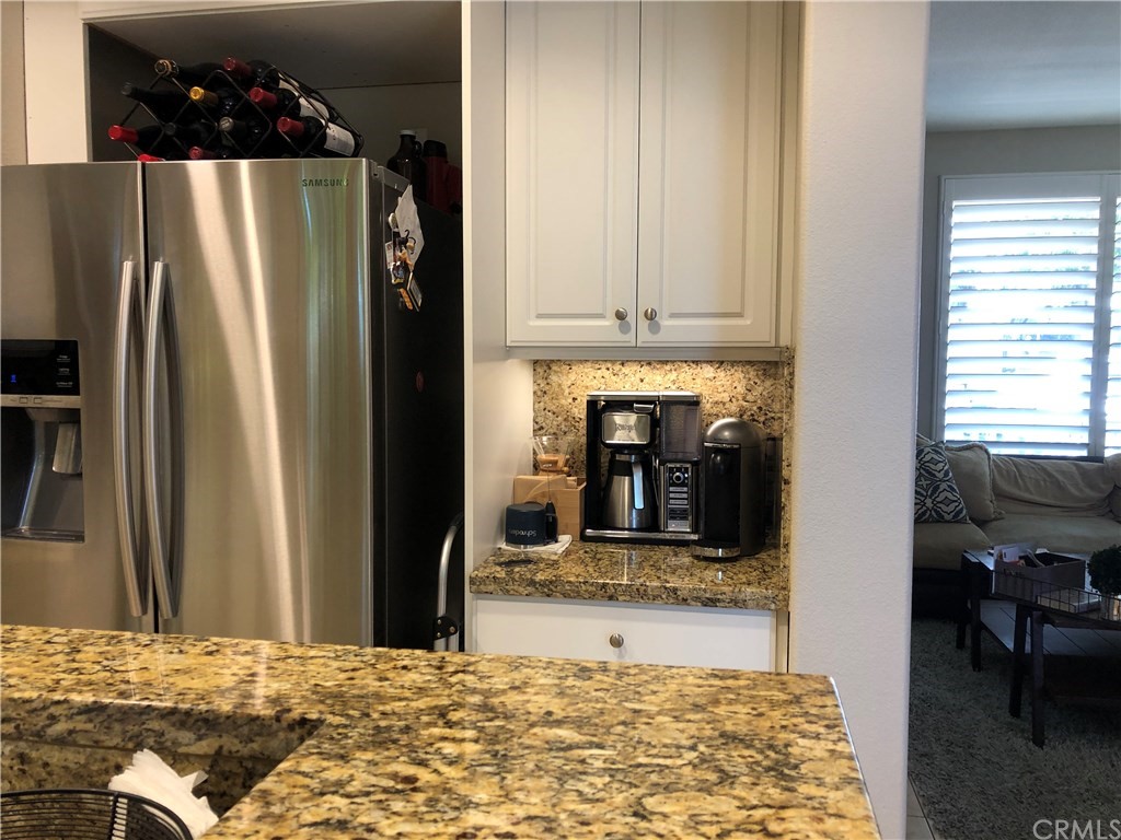 303 Canoe Pond Costa Mesa, CA 92627 - Photo 10 of 49 a kitchen with refrigerator and window
