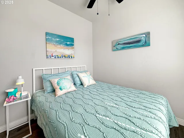 a bedroom with a bed and ceiling fan