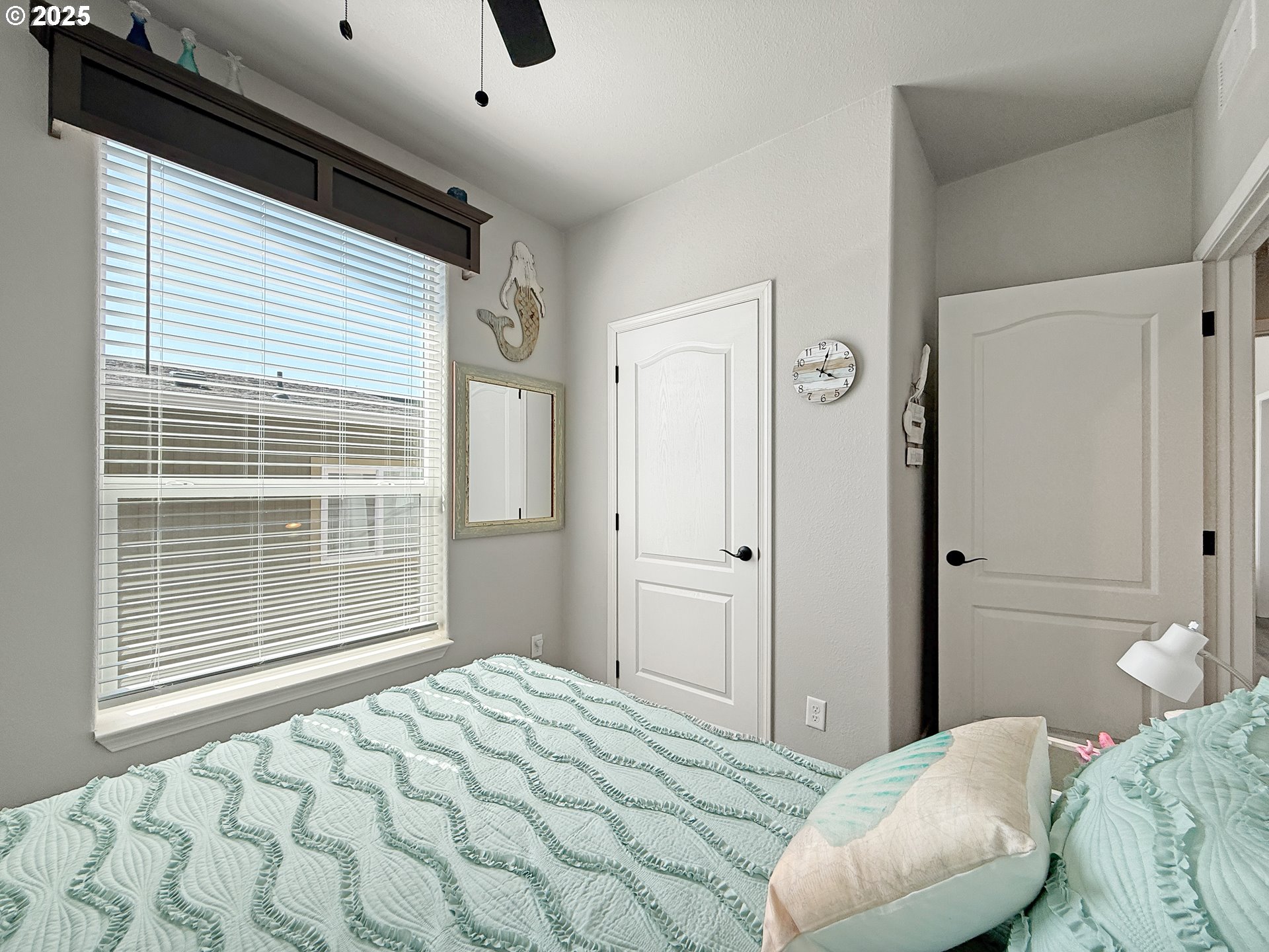 15889 Sunset Strip, Unit 44 Brookings, OR 97415 - Photo 25 of 44 a bedroom with a bed and a large window