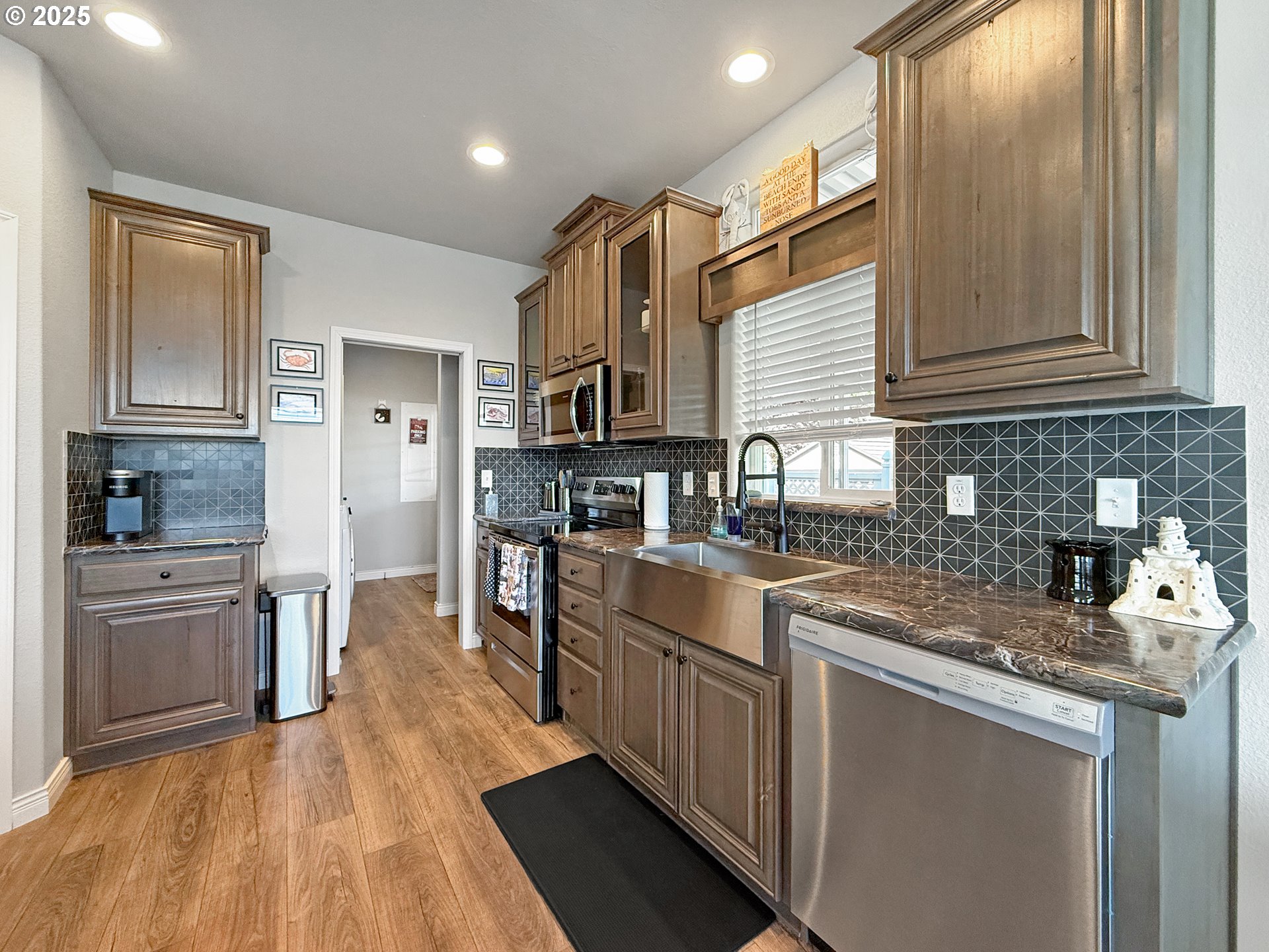 15889 Sunset Strip, Unit 44 Brookings, OR 97415 - Photo 29 of 44 a kitchen with stainless steel appliances granite countertop a sink stove and refrigerator