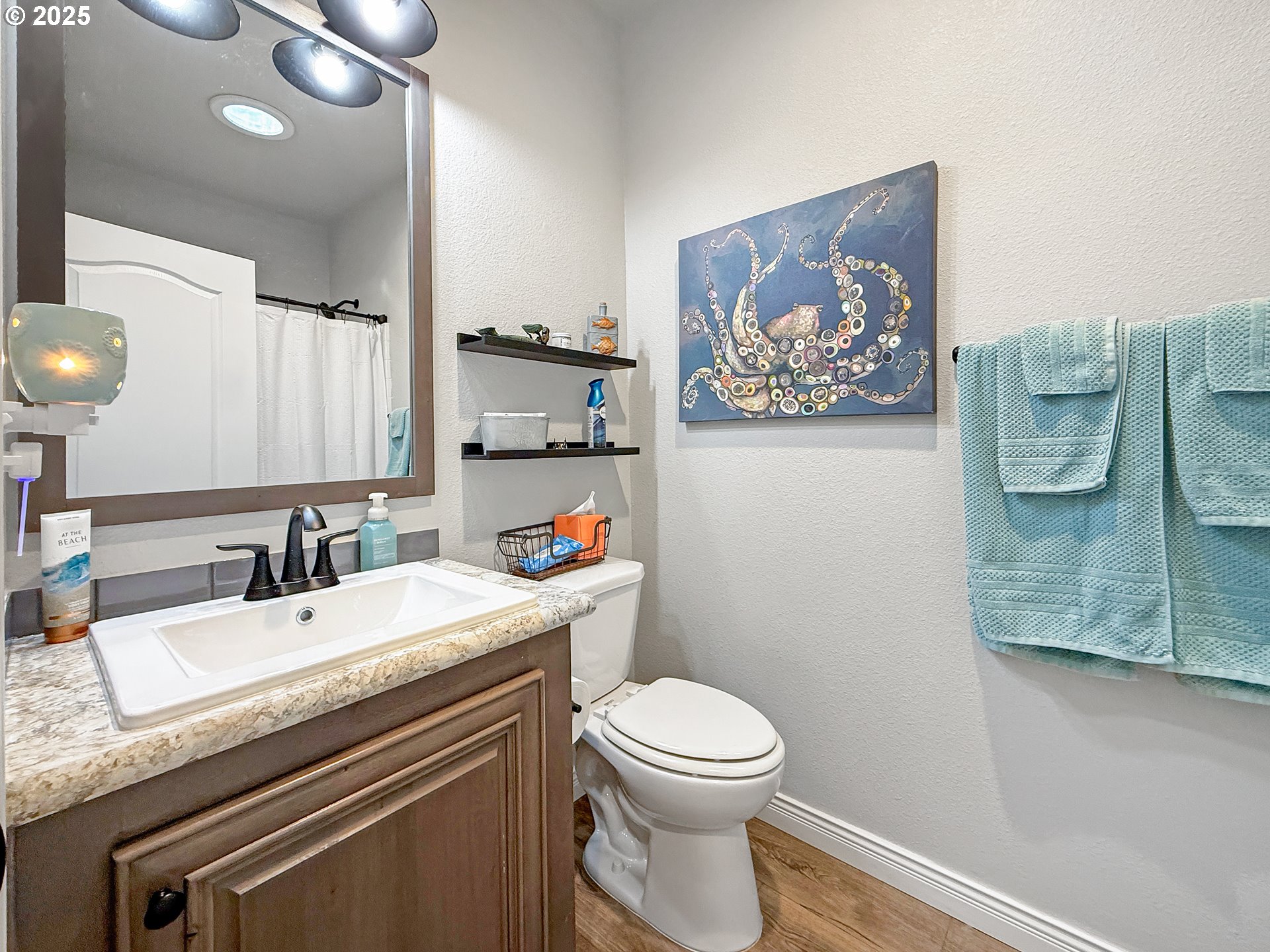 15889 Sunset Strip, Unit 44 Brookings, OR 97415 - Photo 33 of 44 a bathroom with a granite countertop sink mirror vanity and toilet