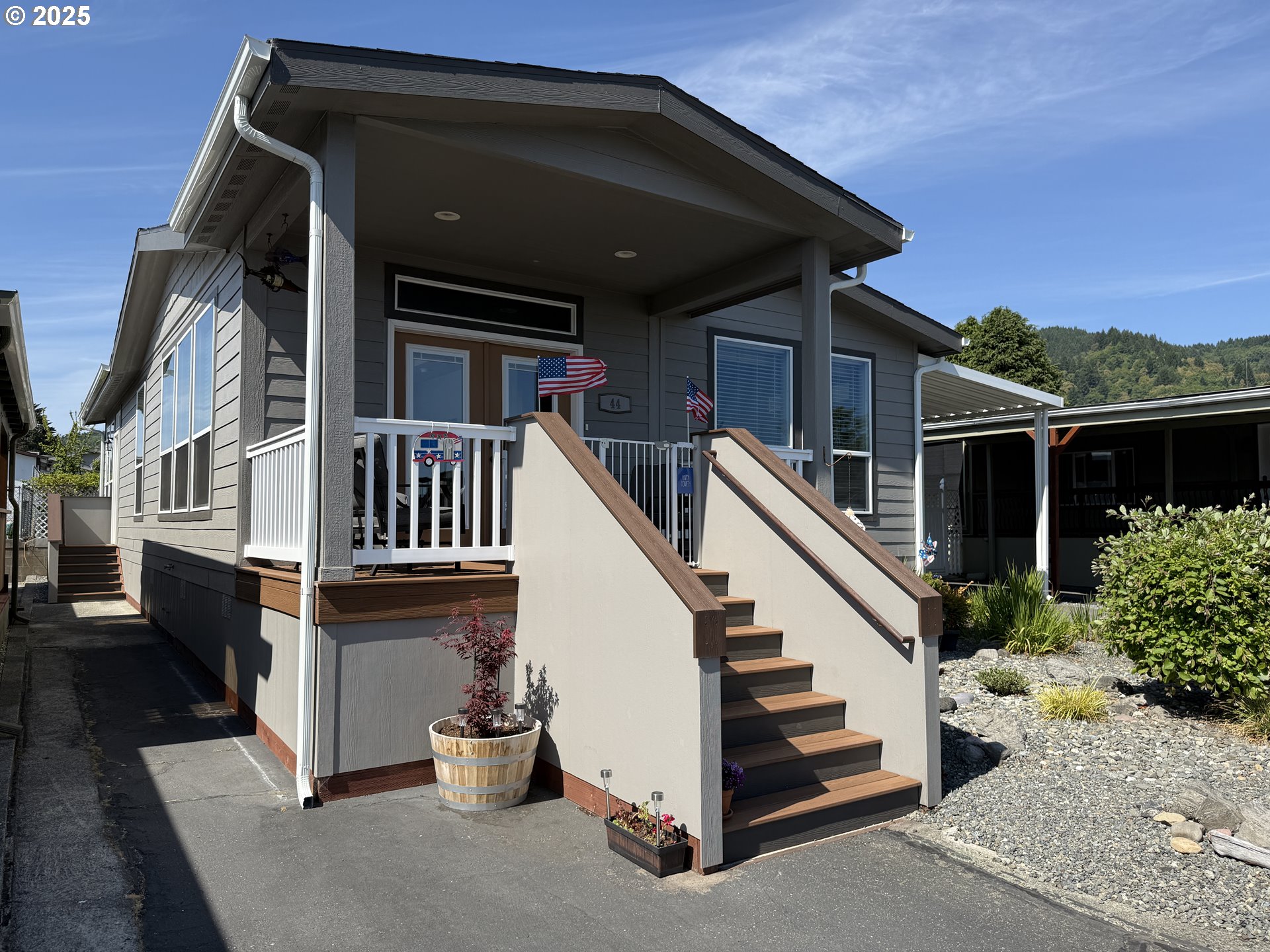 15889 Sunset Strip, Unit 44 Brookings, OR 97415 - Photo 39 of 44 a view of a house with a small yard and stairs