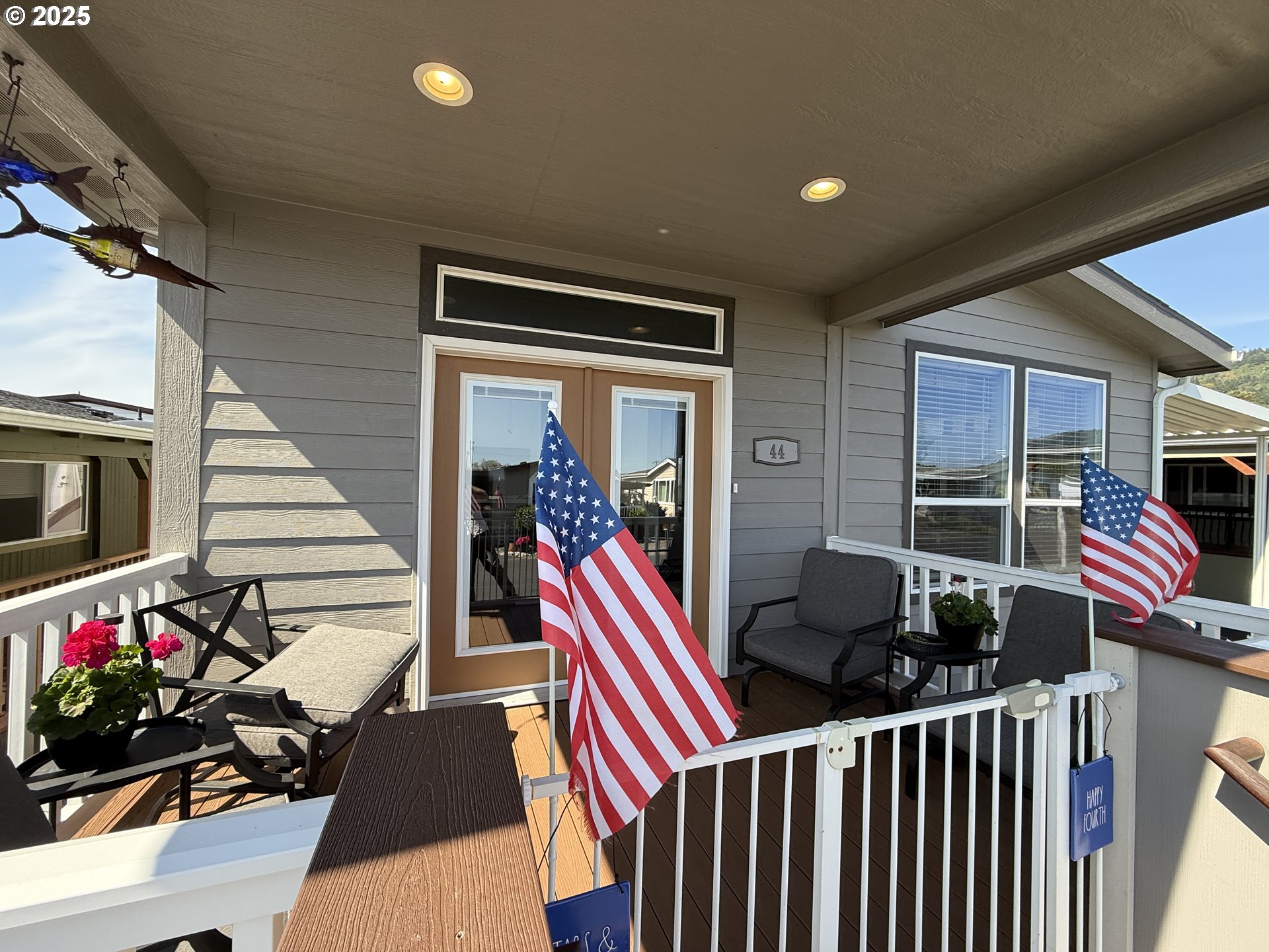 15889 Sunset Strip, Unit 44 Brookings, OR 97415 - Photo 44 of 44 a living room with furniture a flat screen tv and a floor to ceiling window