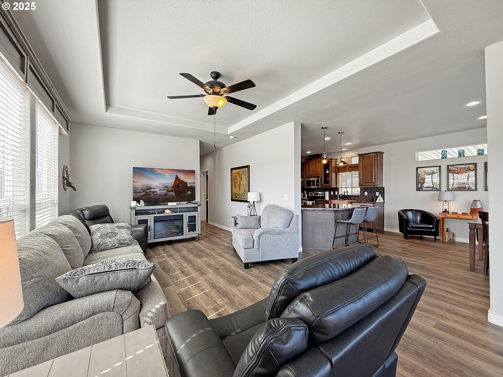 15889 Sunset Strip, Unit 44 Brookings, OR 97415 - Photo 7 of 44 a living room with furniture a fireplace and a flat screen tv
