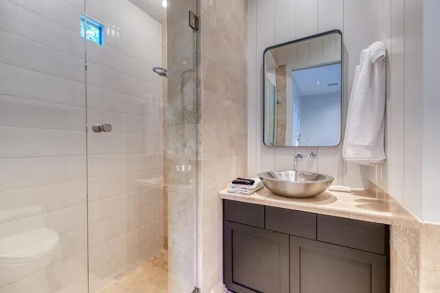 a bathroom with a sink a toilet and shower