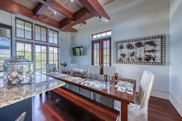 a dining room with furniture and wooden floor