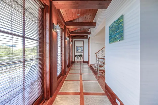 a view of a hallway with wooden floor and staircase