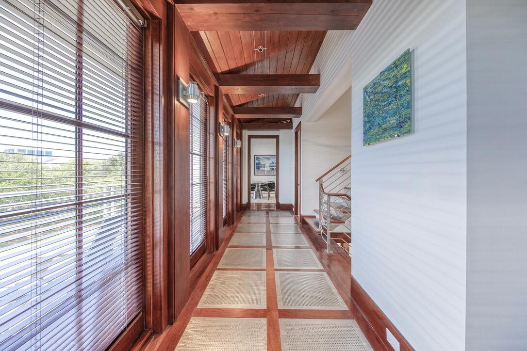210 Village Way Panama City Beach, FL 32413 - Photo 19 of 56 a view of a hallway with wooden floor and staircase