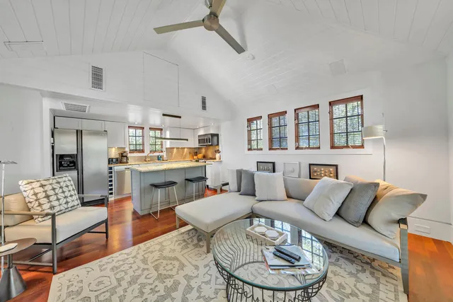 a kitchen with kitchen island a counter top space a sink appliances and cabinets