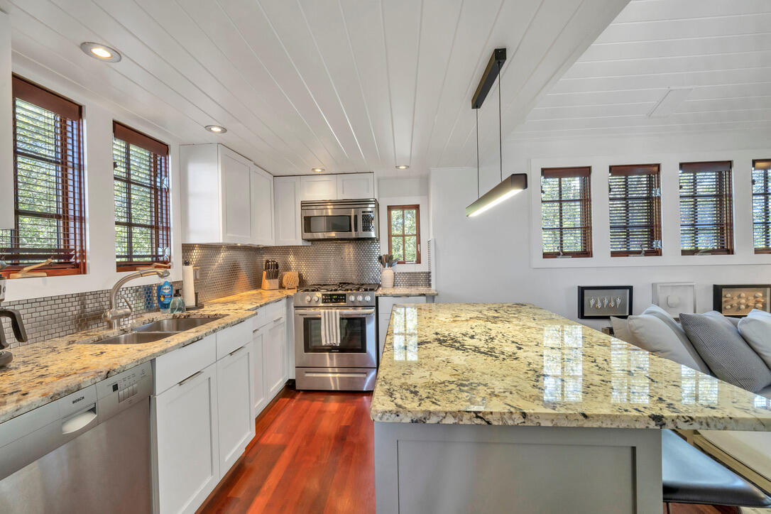 210 Village Way Panama City Beach, FL 32413 - Photo 34 of 56 a kitchen with stainless steel appliances granite countertop a sink stove and refrigerator
