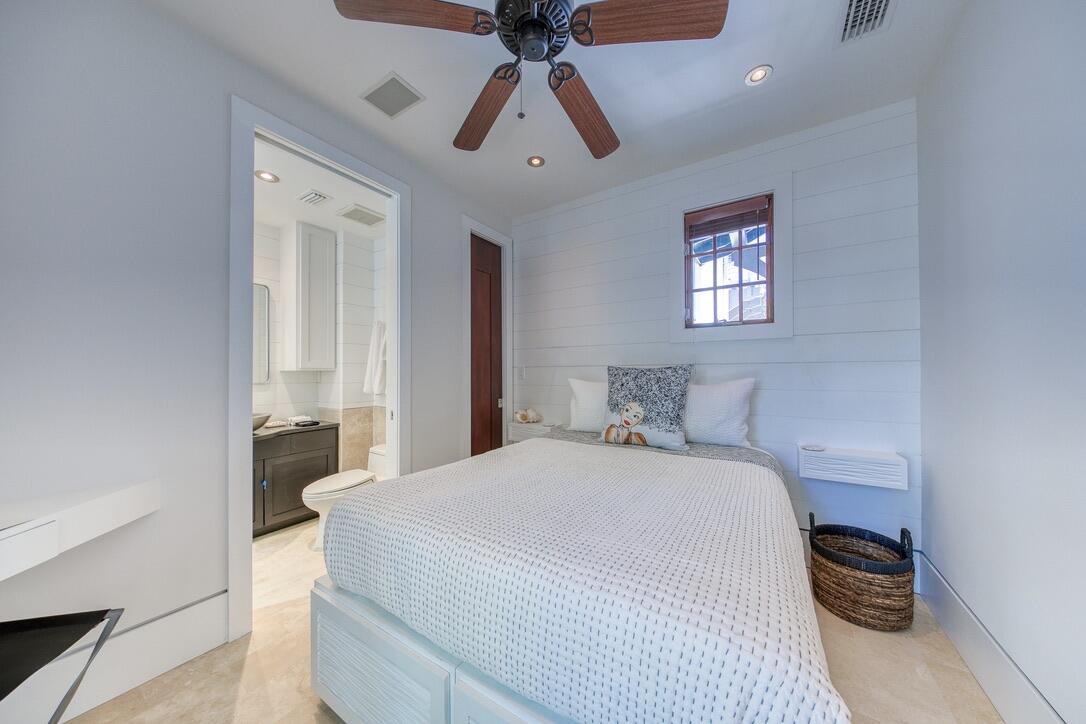 210 Village Way Panama City Beach, FL 32413 - Photo 38 of 56 a bedroom with a bed and a chandelier