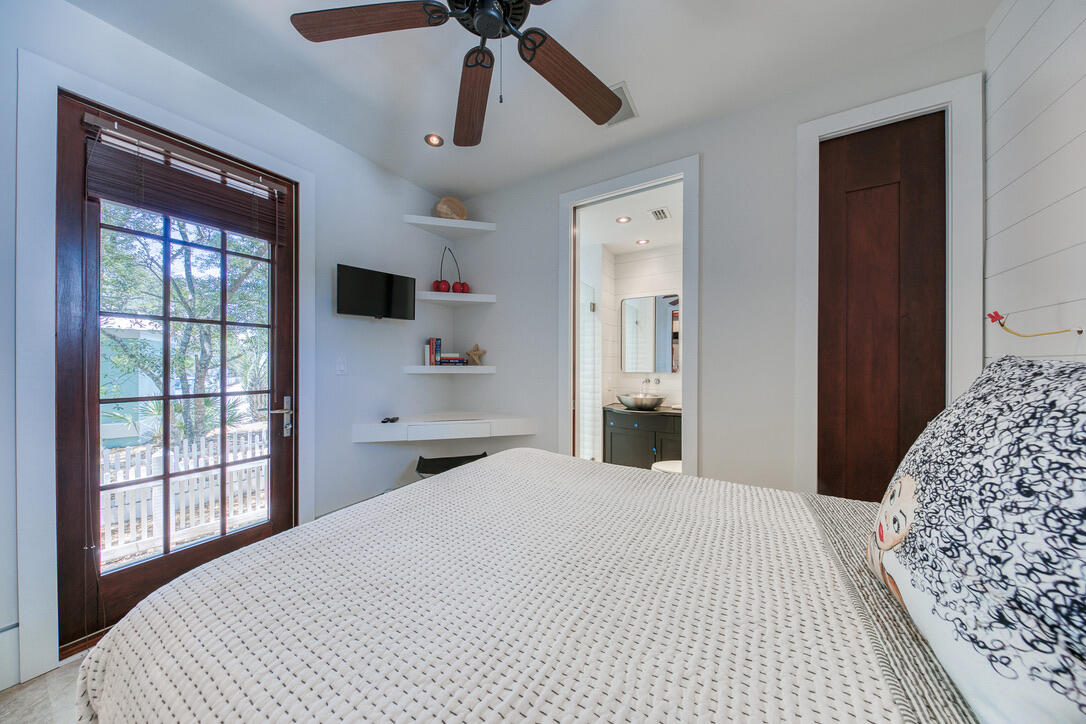 210 Village Way Panama City Beach, FL 32413 - Photo 39 of 56 a bedroom with a large bed and a window