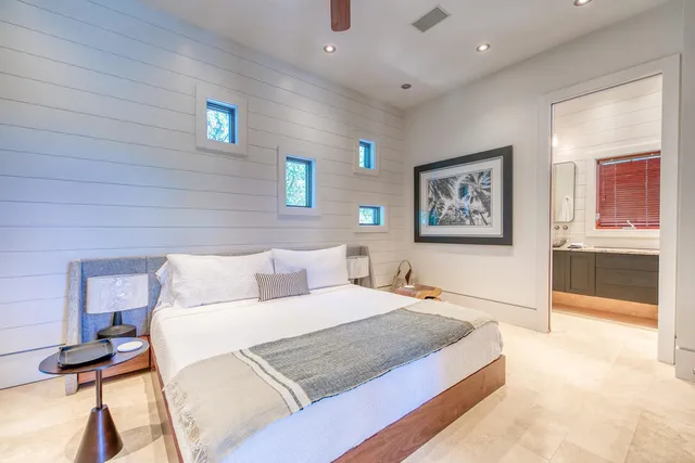 a bedroom with a bed and a lamp on table