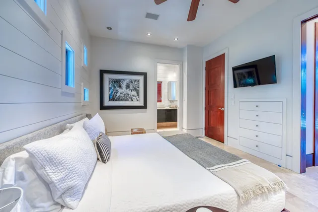 a bedroom with a large bed and a tv