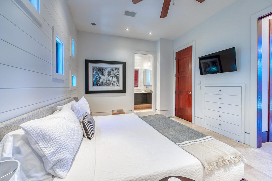 210 Village Way Panama City Beach, FL 32413 - Photo 6 of 56 a bedroom with a large bed and a tv