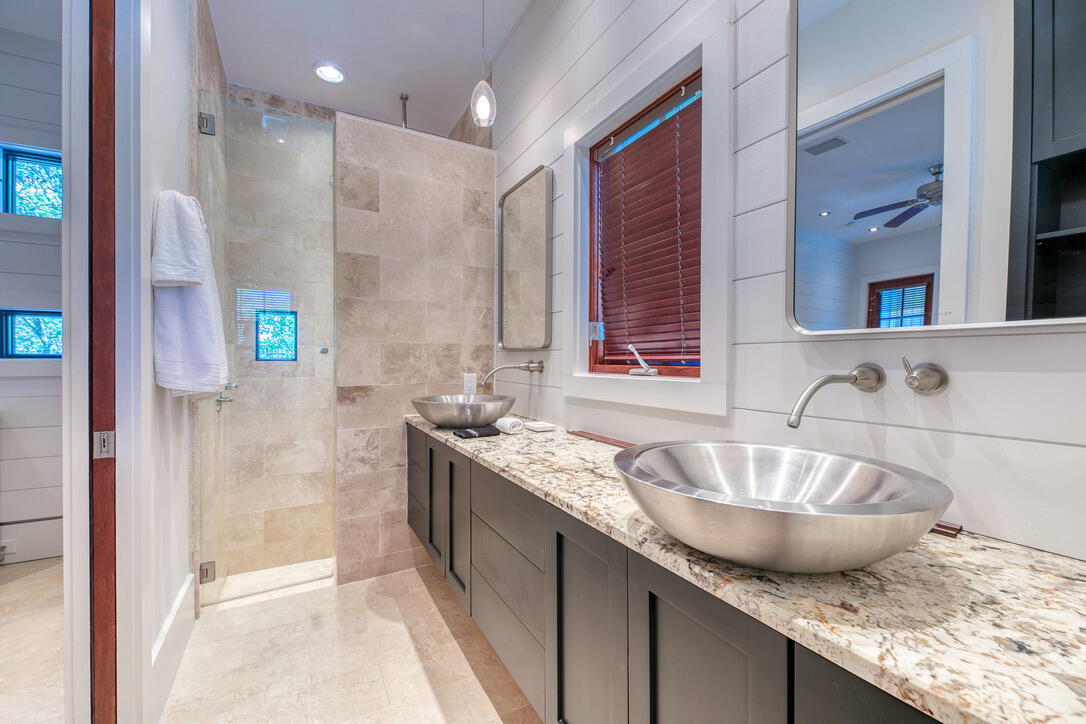 210 Village Way Panama City Beach, FL 32413 - Photo 7 of 56 a bathroom with a granite countertop sink a mirror and shower