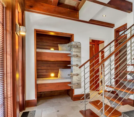 a yellow room with wooden floor and windows