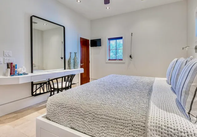 a bedroom with a bed and a table in it