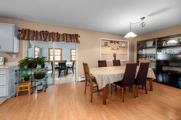 a view of a dining room with furniture and wooden floor