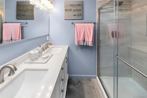 a bathroom with a sink vanity and a mirror