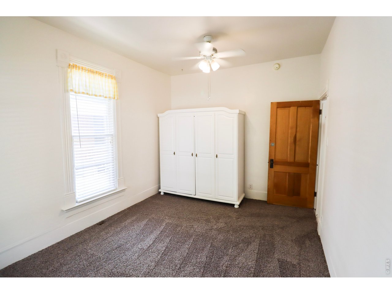 608 South Howes Street Fort Collins, CO 80521 - Photo 13 of 28 a view of an empty room with wooden floor