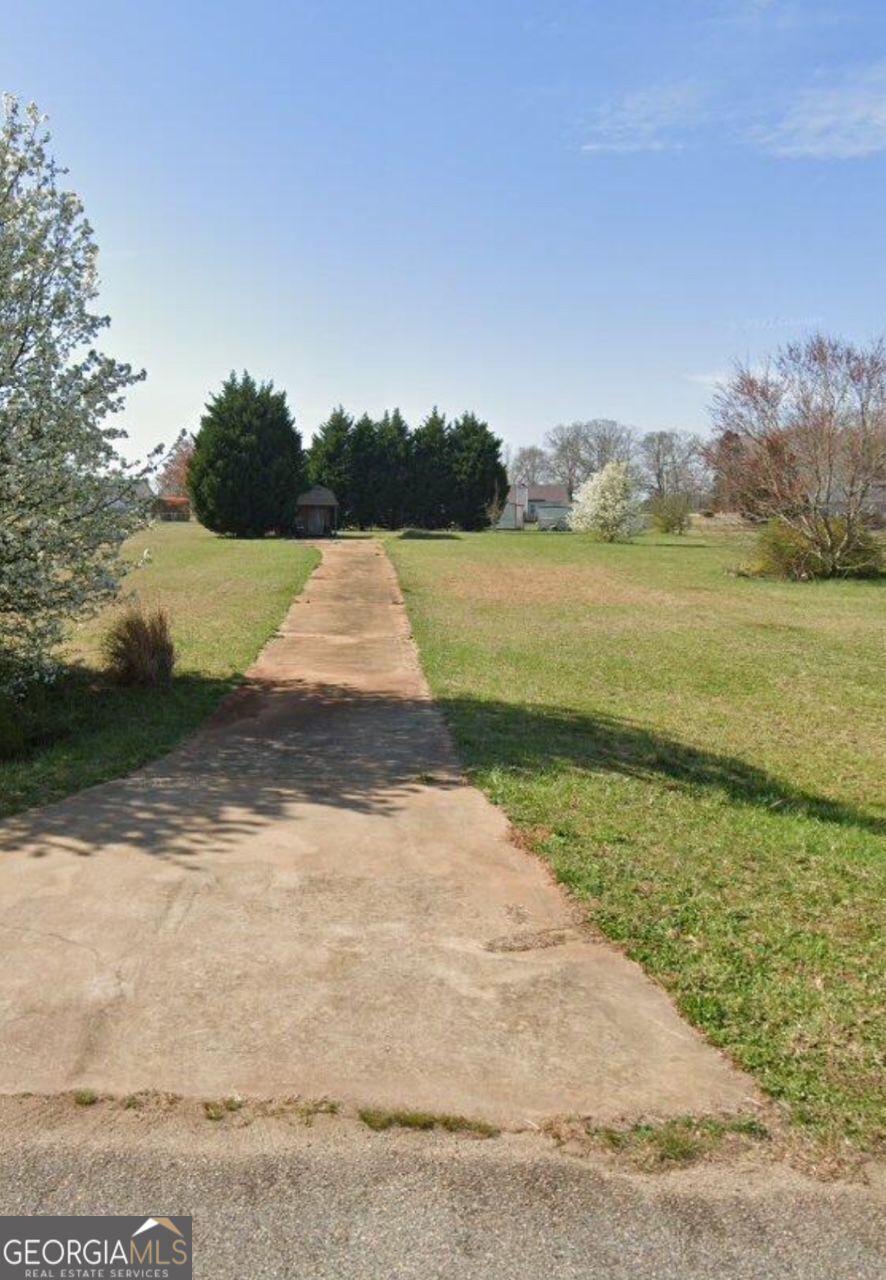 121 Wilder Way Williamson, GA 30292 - Photo 2 of 3 a view of a lake from a yard