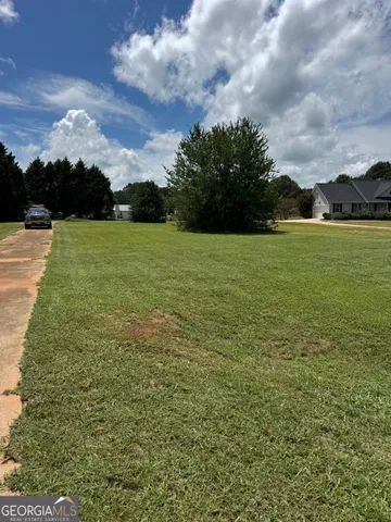 a view of a field with an ocean