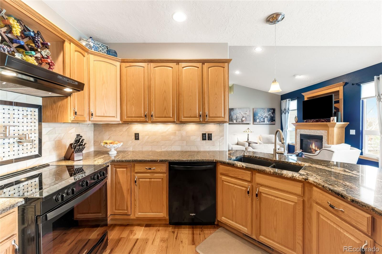 2013 Trail Ridge Drive Severance, CO 80615 - Photo 11 of 49 a kitchen with stainless steel appliances a sink stove and cabinets
