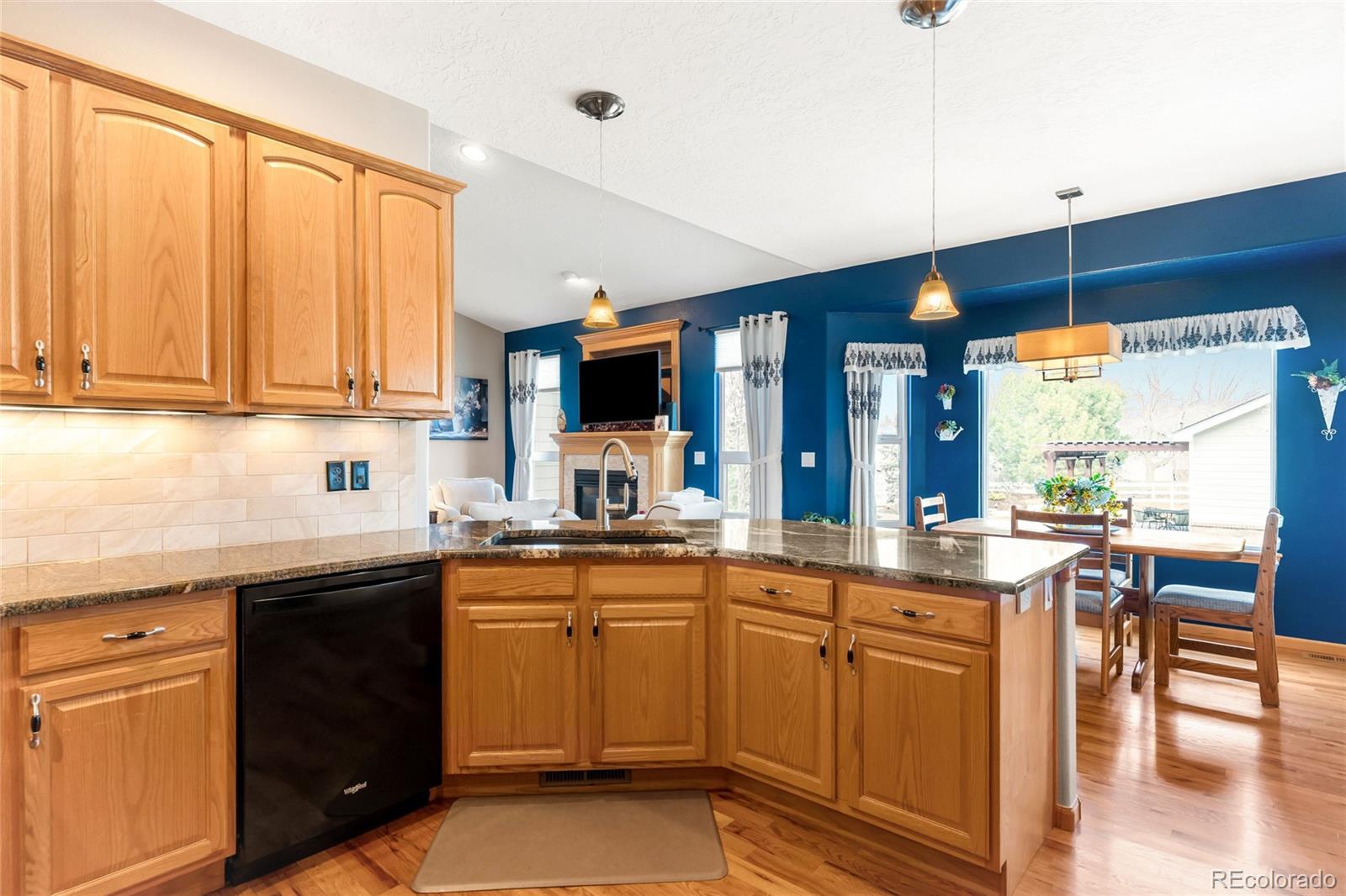 2013 Trail Ridge Drive Severance, CO 80615 - Photo 12 of 49 a kitchen with stainless steel appliances granite countertop sink stove top oven and cabinets