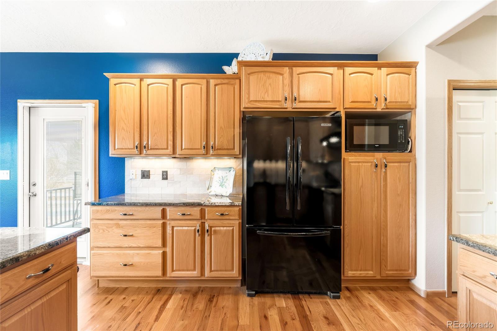 2013 Trail Ridge Drive Severance, CO 80615 - Photo 13 of 49 a kitchen with granite countertop stainless steel appliances a refrigerator and cabinets