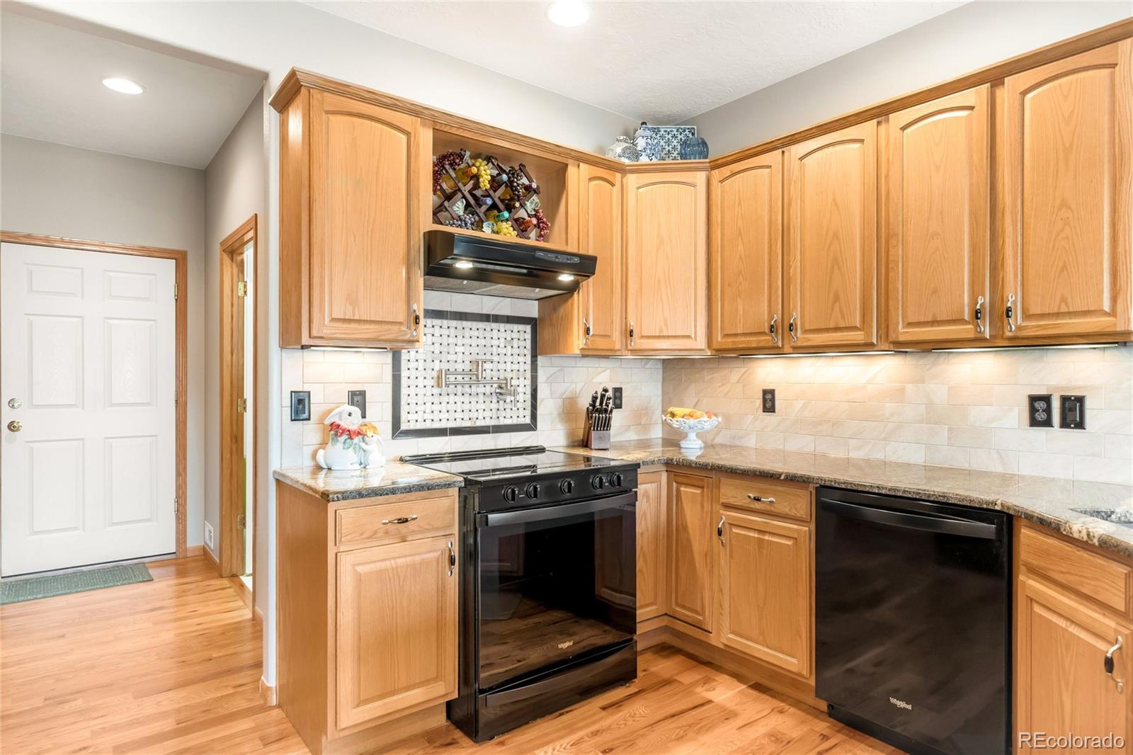 2013 Trail Ridge Drive Severance, CO 80615 - Photo 14 of 49 a kitchen with stainless steel appliances granite countertop a stove a sink and a microwave