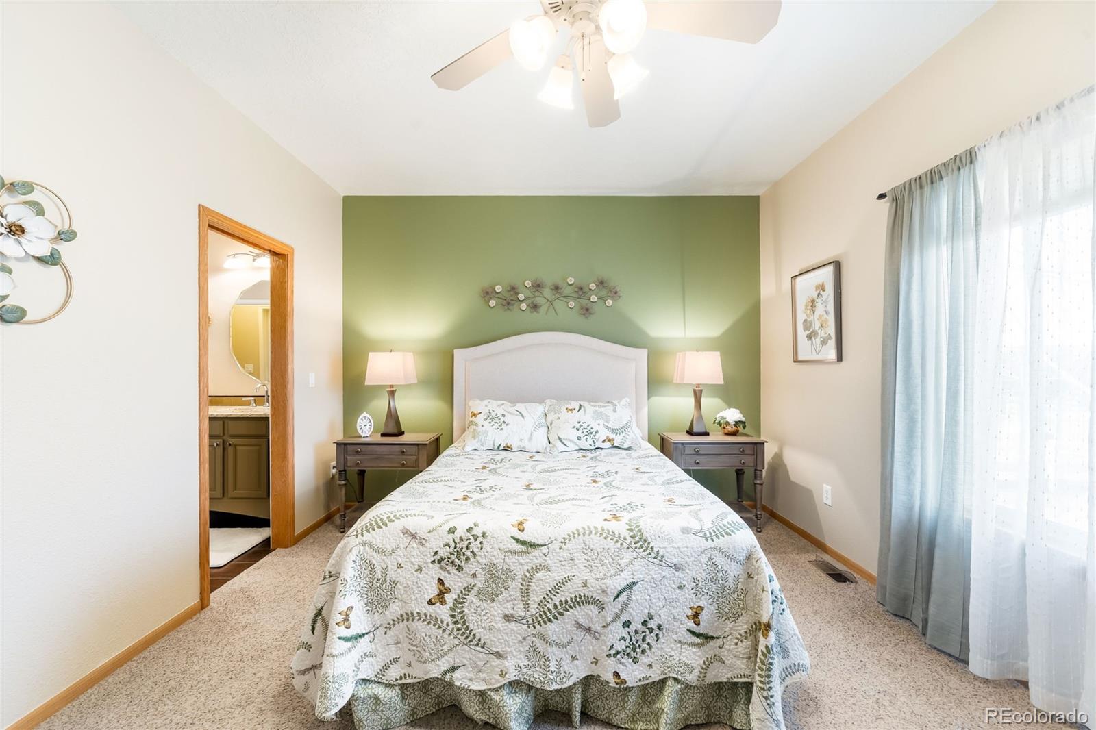 2013 Trail Ridge Drive Severance, CO 80615 - Photo 16 of 49 a spacious bedroom with a bed and a window