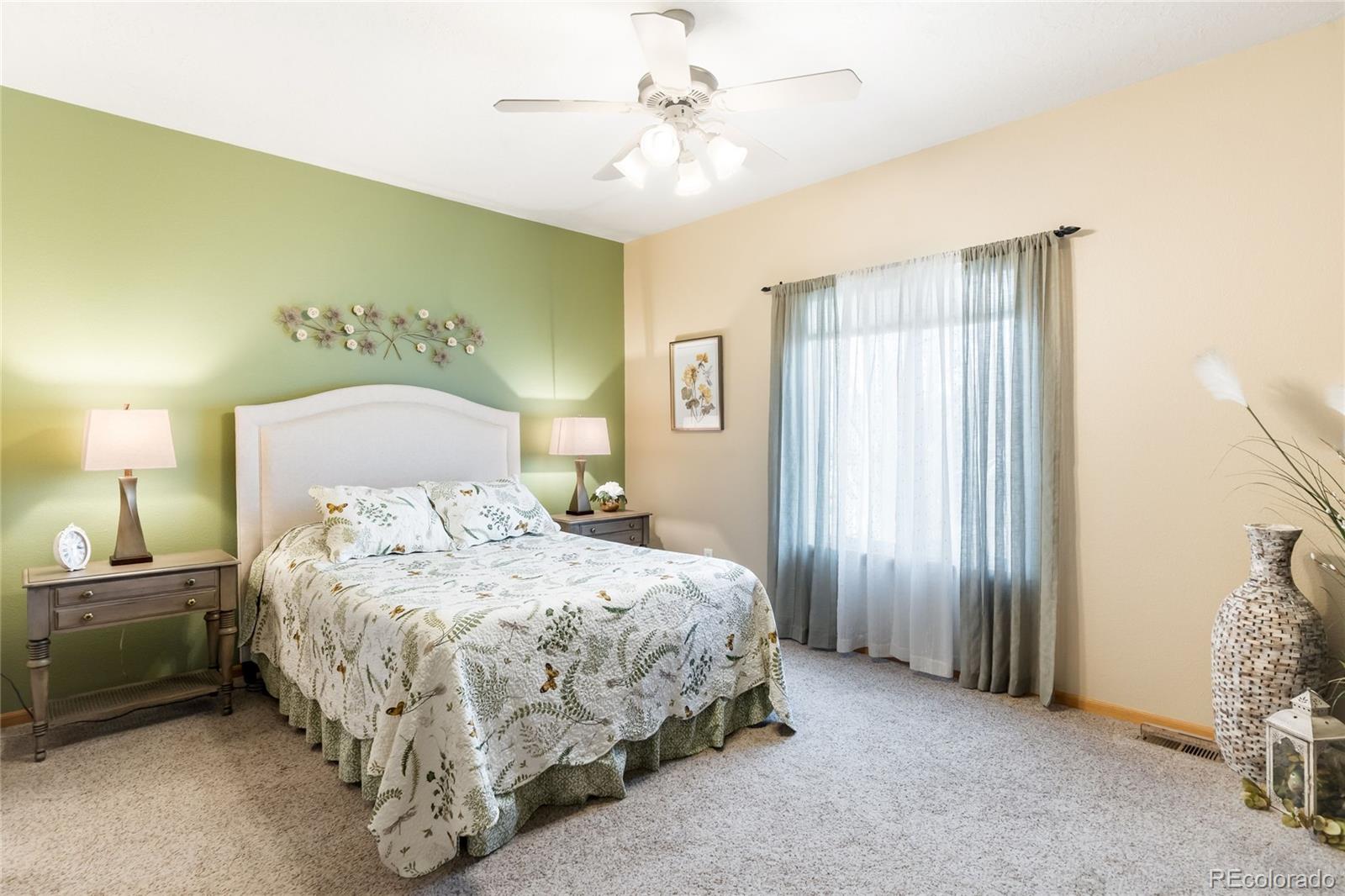 2013 Trail Ridge Drive Severance, CO 80615 - Photo 17 of 49 a bedroom with a bed and a chandelier