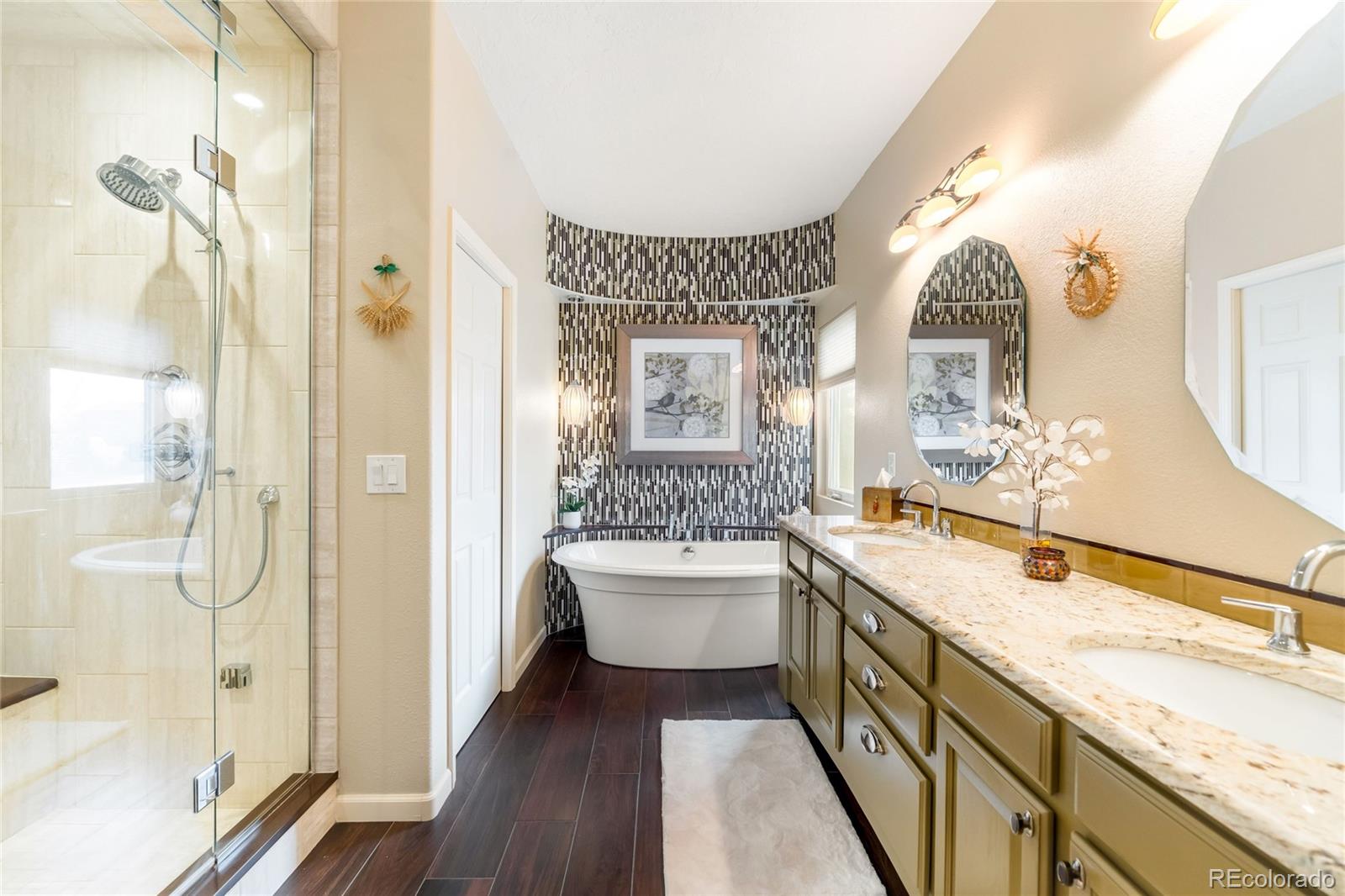 2013 Trail Ridge Drive Severance, CO 80615 - Photo 18 of 49 a bathroom with a granite countertop sink mirror and a bathtub