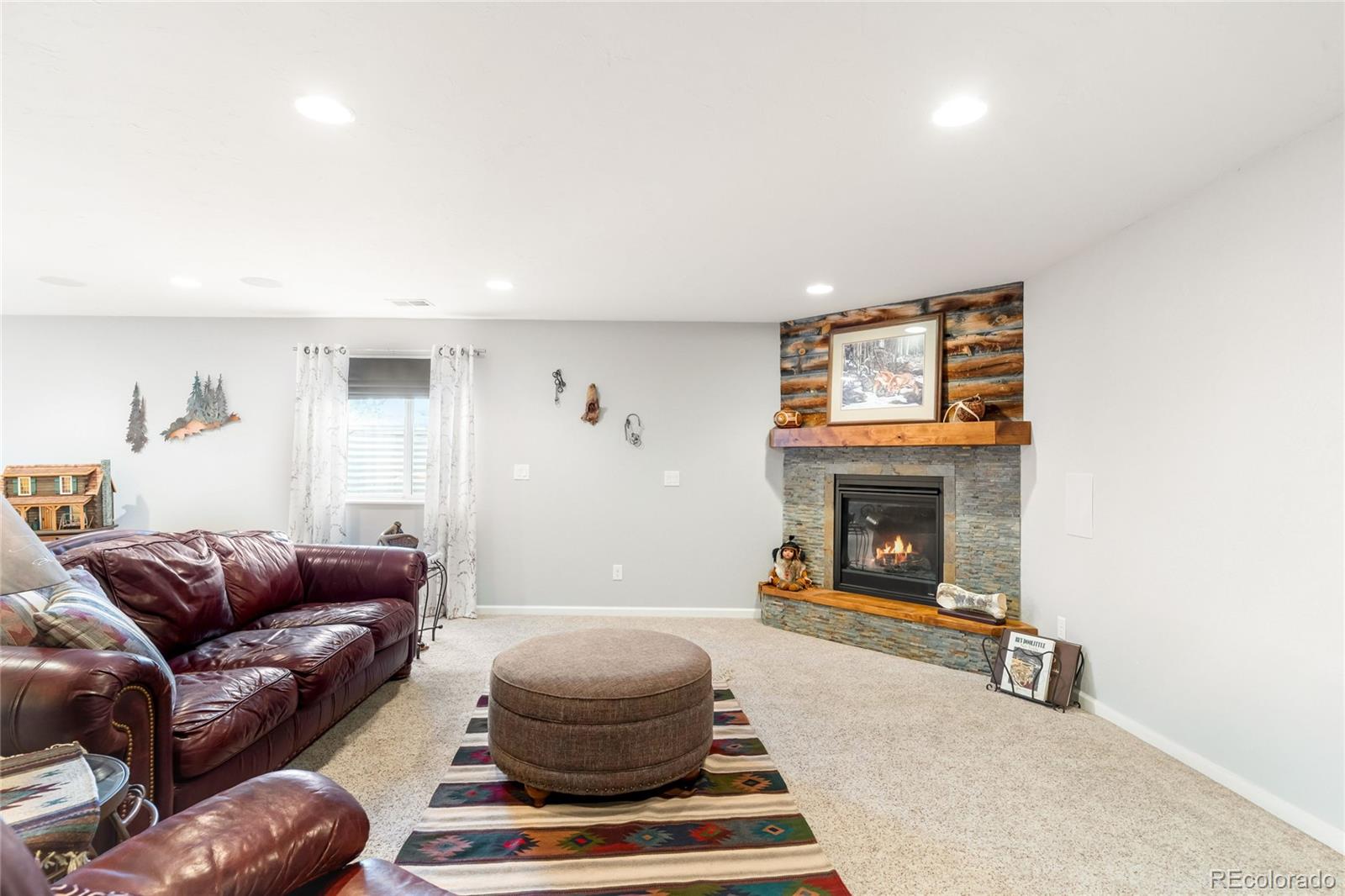 2013 Trail Ridge Drive Severance, CO 80615 - Photo 34 of 49 a living room with furniture and a fireplace